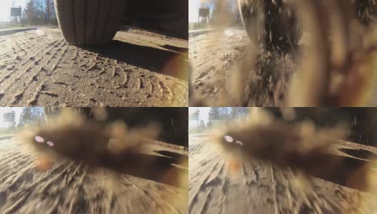 启动汽车轮胎快速旋转投掷泥土进入相机的慢动作高清在线视频素材下载
