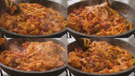 慢动作搅拌和烹饪意大利扁面，配上番茄酱、橄榄和蘑菇高清在线视频素材下载