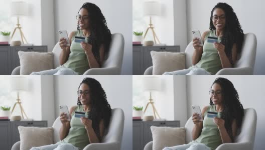 女人拿着信用卡用智能手机高清在线视频素材下载