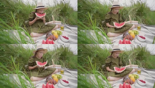 女孩在户外野餐吃一块西瓜。青少年度过他的空闲时间。健康心理健康概念。新鲜水果环保高清在线视频素材下载