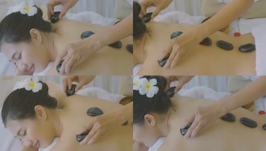 美丽的亚洲女人享受热石按摩治疗高清在线视频素材下载