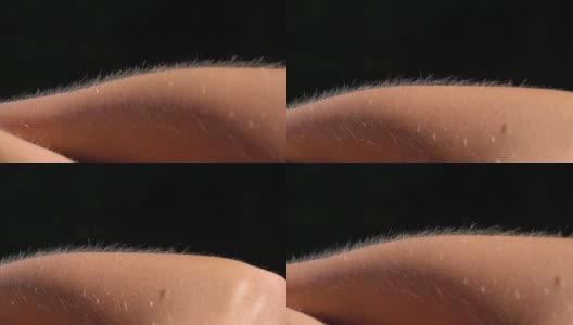 近距离微距景深:皮肤起鸡皮疙瘩的细节，女性手臂上的毛发上升高清在线视频素材下载