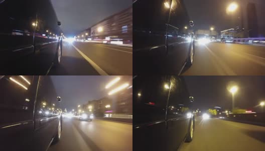 快速城市驾驶夜间道路POV通过城市在夜间时间推移左侧的汽车。低角度的观点。相机拍摄回来高清在线视频素材下载