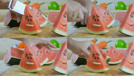 近距离拍摄的女人的手用菜刀切熟西瓜木板上的夏天新鲜水果高清在线视频素材下载