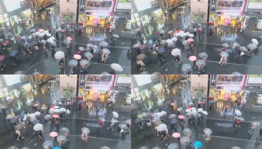 日本大阪道顿堀大街上，一群打着伞的人在下雨高清在线视频素材下载