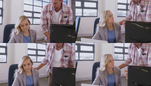 男性和女性商务主管在笔记本电脑前讨论高清在线视频素材下载