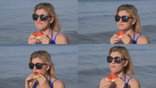 一个戴墨镜的女人坐在海滩上吃西瓜。一个金发女郎手里拿着一个成熟的西瓜高清在线视频素材下载