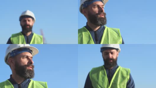 留着胡子、头戴黄色头盔、身穿黄色背心的工头正在检查建筑工地。港口工人高清在线视频素材下载