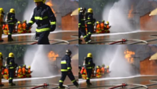 消防队员使用消防水龙带灭火的模糊镜头高清在线视频素材下载