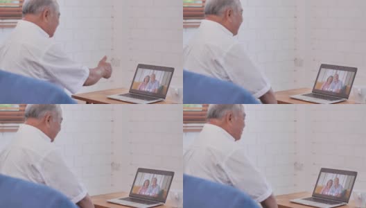 亚洲老爷爷在视频会议上与亚洲夫妇在家中进行视频通话，在社交过程中使用电脑和视频会议技术保持距离。社会电话会议高清在线视频素材下载