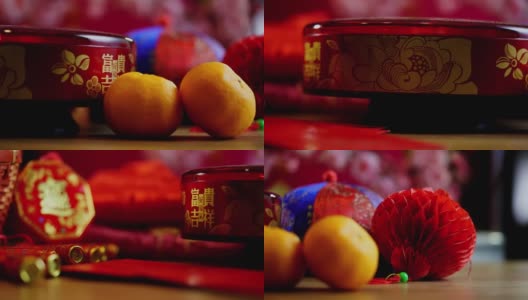 木桌上放着橘子、红灯笼和中国红包高清在线视频素材下载