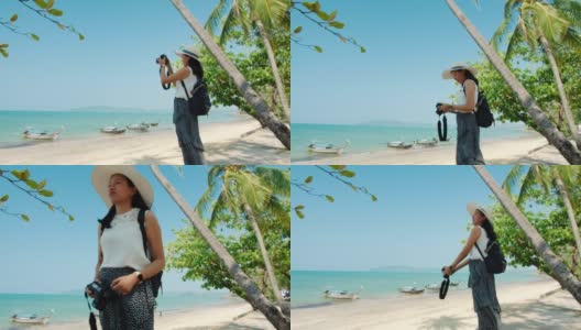 亚洲美女在周末度假的海边用相机拍照。快乐独自旅行的概念。4 k慢动作。高清在线视频素材下载