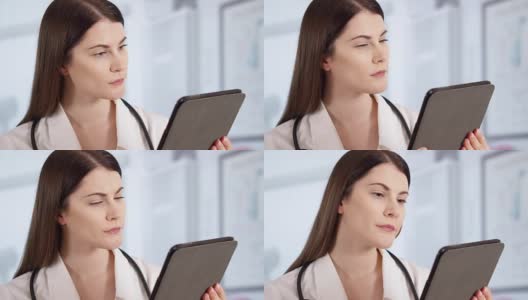 专业女医生用听诊器在病房使用平板。在职女医生高清在线视频素材下载