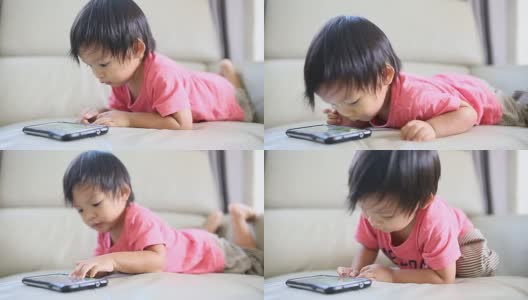 亚洲男婴使用手机。高清在线视频素材下载
