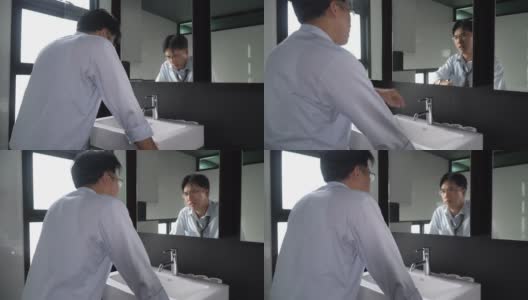 愤怒的亚洲商人站在镜子前责备自己高清在线视频素材下载