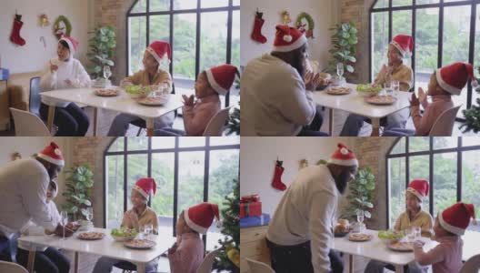 多代同堂的家庭戴着圣诞帽，在家里一起享用圣诞大餐高清在线视频素材下载