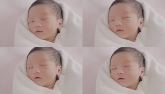 快乐亚洲可爱的儿子新生婴儿睡觉。新出生的。高清在线视频素材下载