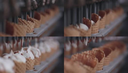 向冰淇淋筒内填充冰淇淋的机器的特写镜头。高清。高清在线视频素材下载
