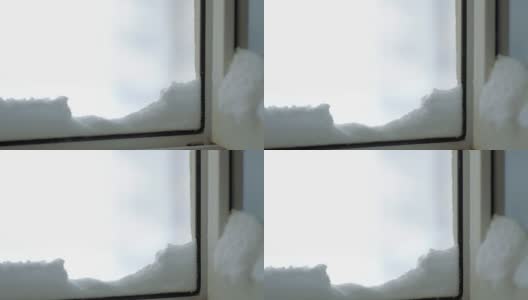 特写抽象的雪飞进房子，躺在打开的窗户上。高清在线视频素材下载