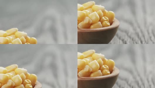 木桌上的木碗里装着甜玉米罐头高清在线视频素材下载