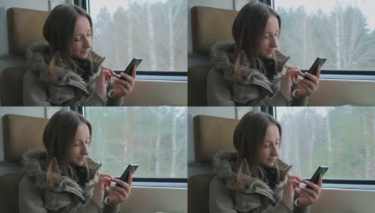 一个在火车上用智能手机的沉思女人高清在线视频素材下载
