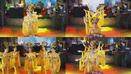 五名亚洲女演员组成的一组，穿着中国传统的黄色服装，跳着“多臂女神”的舞蹈高清在线视频素材下载