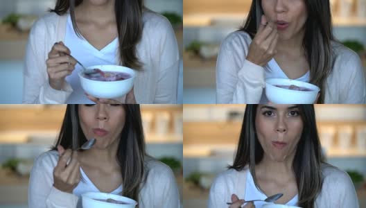 一位拉丁美洲妇女在家享受一碗美味的水果和酸奶高清在线视频素材下载