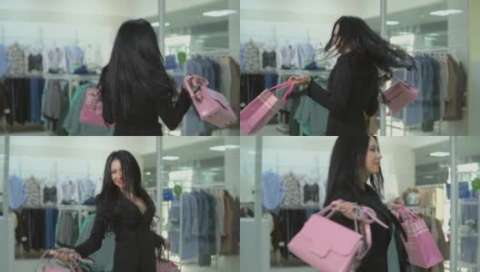 慢动作的女孩拿着包从商店出来购物。高清在线视频素材下载