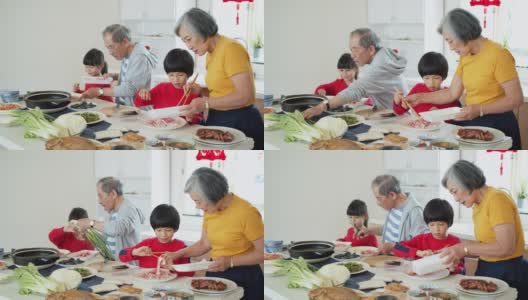 爷爷奶奶向孩子们展示如何在春节做火锅的手持镜头高清在线视频素材下载