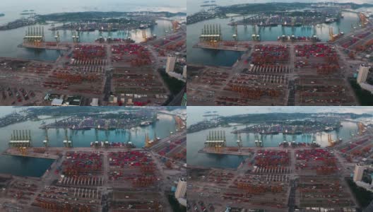 无人机与起重机在新加坡国际港口上空飞行的鸟瞰图高清在线视频素材下载