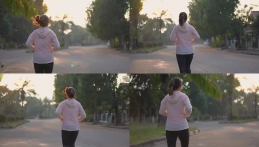 妇女早上在村公园跑步，锻炼和健康的概念高清在线视频素材下载