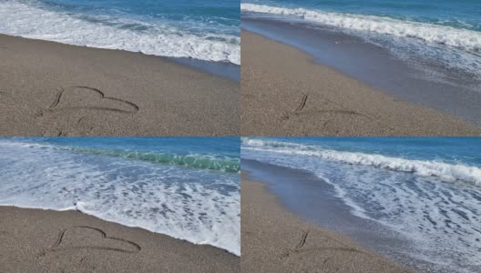 心形符号绘制在沙滩上，背景是柔和的蓝色波浪。海浪的泡沫洗去了画在沙滩上的一颗心。情人节，浪漫的概念。高清在线视频素材下载