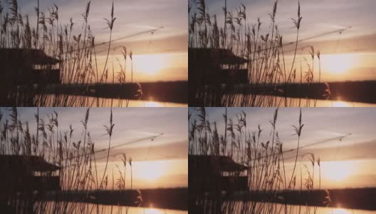 钓鱼棚在河边与美妙的日落高清在线视频素材下载