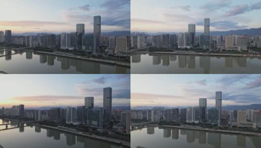 黄昏时分水边城市景观的鸟瞰图高清在线视频素材下载