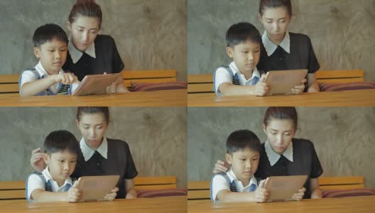亚洲母亲和儿子使用平板电脑高清在线视频素材下载