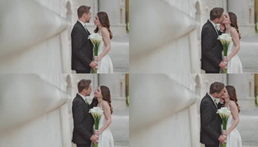 新婚夫妇捧着花束亲吻高清在线视频素材下载