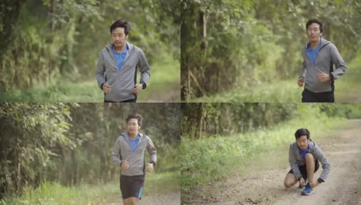 亚洲男人在开始跑步前系上运动鞋高清在线视频素材下载
