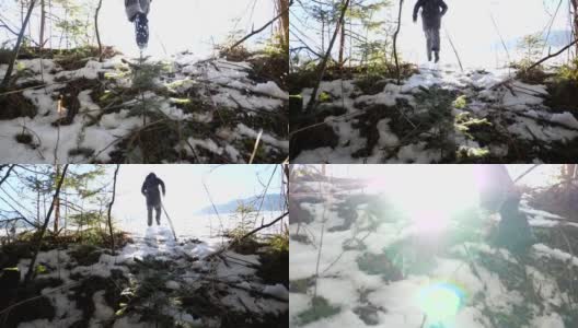 后视图的不可辨认的远足者慢跑上雪坡在冬天的高山森林。一个年轻人在阳光明媚的日子爬山。背景是阳光。旅行或旅行的概念。慢动作高清在线视频素材下载