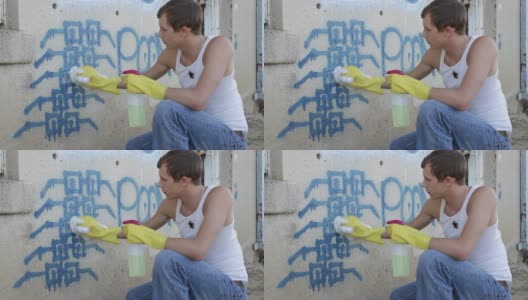 青少年试图清理他的涂鸦高清在线视频素材下载