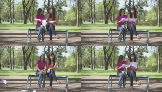 两个开心的女学生把纸扔了，慢镜头高清在线视频素材下载