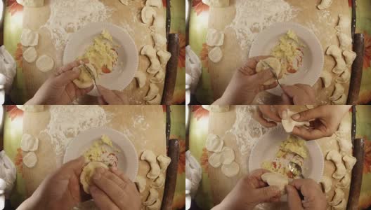 女人的手把煮熟的土豆裹成面团和模子。把它放在盘子附近高清在线视频素材下载
