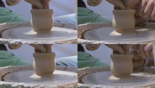 陶工大师的双手和陶工轮上的粘土花瓶高清在线视频素材下载