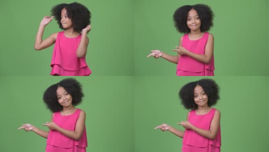 年轻可爱的非洲女孩与非洲式头发显示一些东西高清在线视频素材下载