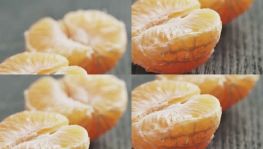 成熟的橘子在木桌上剥皮高清在线视频素材下载