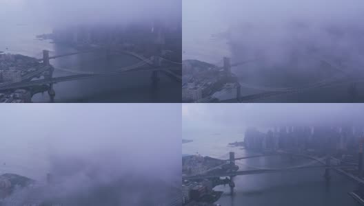 在雾蒙蒙的早晨，沿着东河飞过布鲁克林和曼哈顿大桥。高清在线视频素材下载