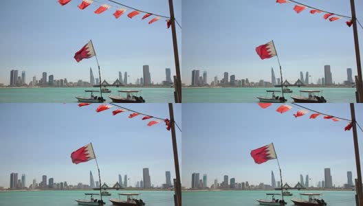 巴林。渔船，旗帜和麦纳麦天际线高清在线视频素材下载