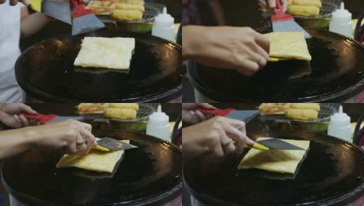 在越南夜市，小贩用香蕉煎薄饼。亚洲的街头食品。4 k高清在线视频素材下载