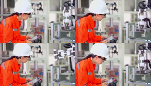 女工程师正在设置工业机器人高清在线视频素材下载