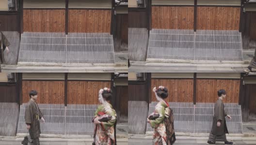 舞妓(正在训练的艺妓)和一个男人在日本老街道鞠躬袴高清在线视频素材下载