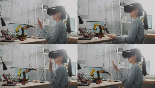 工程师戴着虚拟现实头戴式耳机，打手势时坐在办公桌前工作高清在线视频素材下载